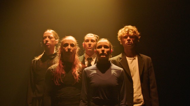 5 olive-skinned people look out into the distance bathed in a warm light