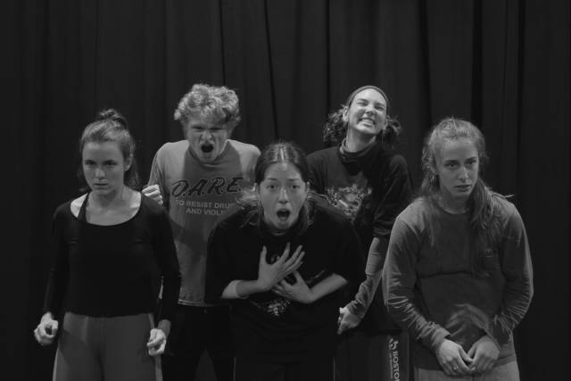 6 people grouped together facing forward in various extreme states of emotion