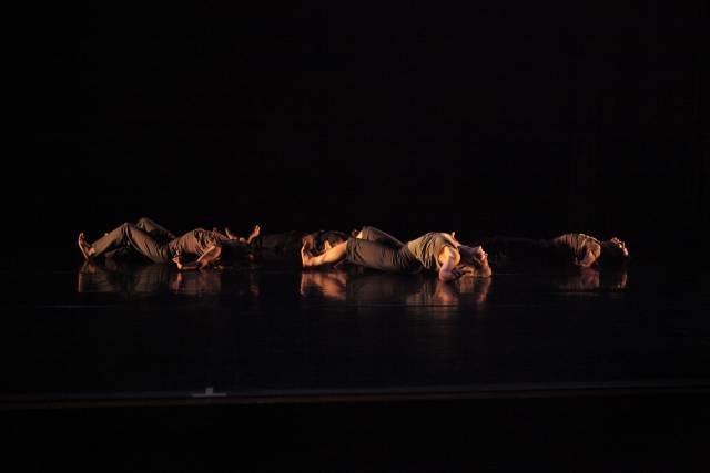 a group of people laying on the floor with their backs arched
