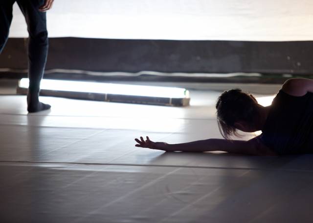 woman lays on her side with one arm outstretched