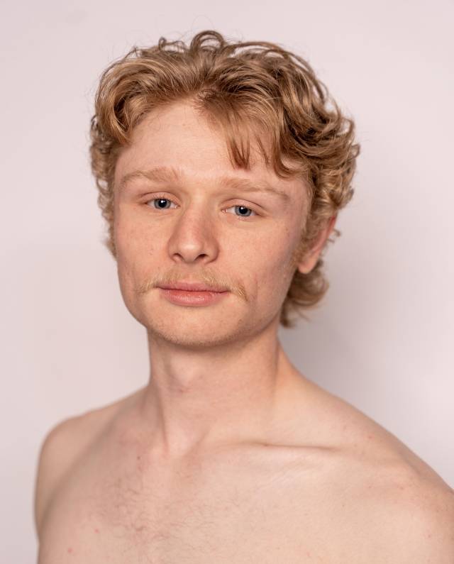 a fair skinned man in a headshot