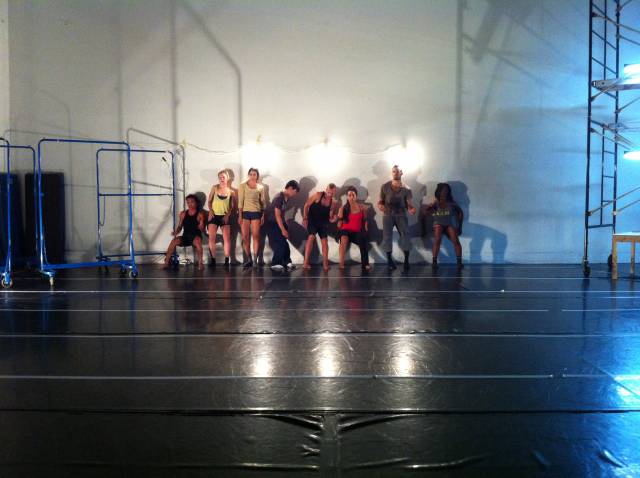 a group of dancers slide down a wall