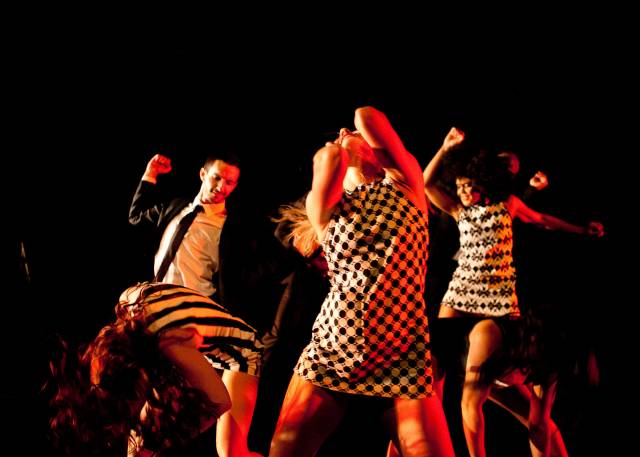a group of dancers thrash around