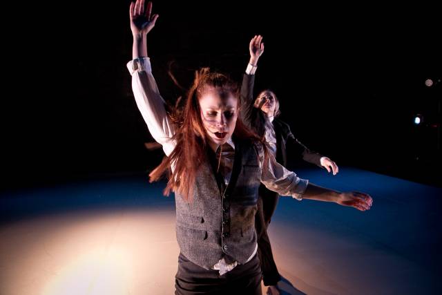 two women raise their arms