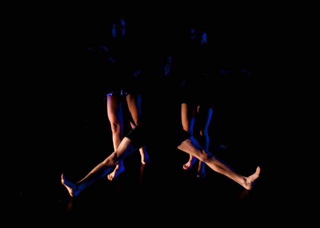 legs extend out from the darkness