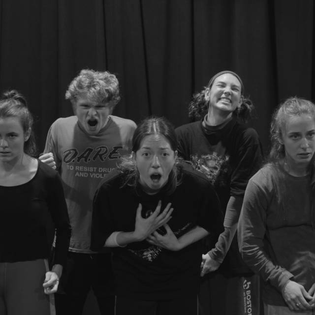 6 people grouped together facing forward in various extreme states of emotion