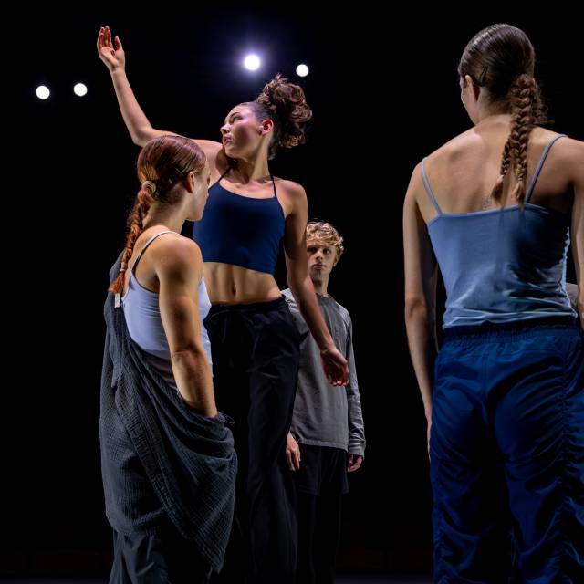 a fair skinned woman is in mid-air while being surround by 3 people