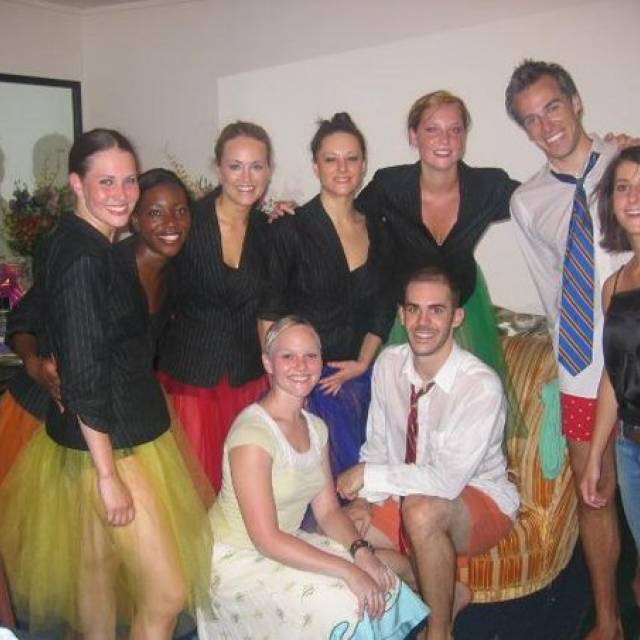 9 people pose for the camera in various costumes
