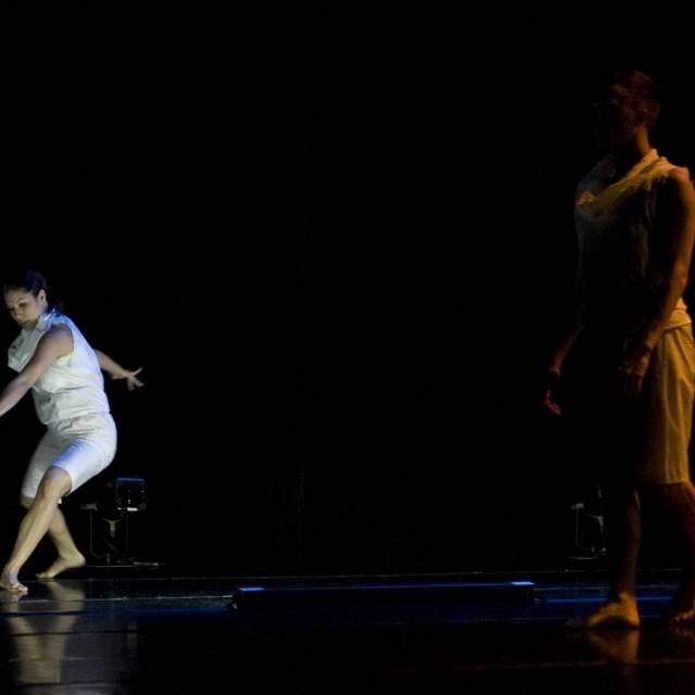 a figure wearing white in motion