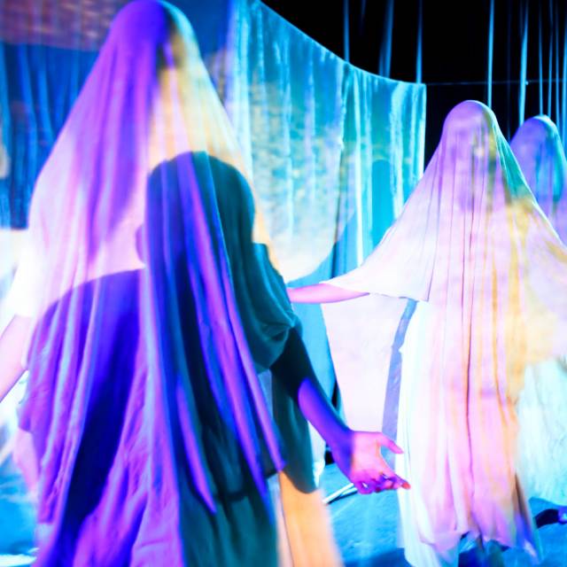 several figures draped in cloth with projections on their clothing
