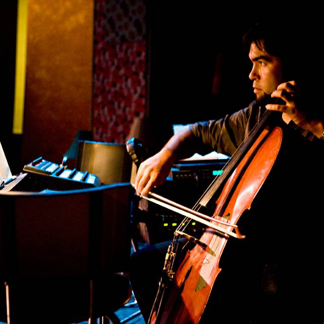 medium skinned man plays the cello