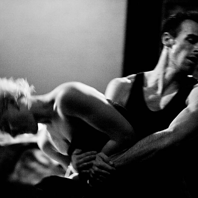 black and white image of man and woman tussling