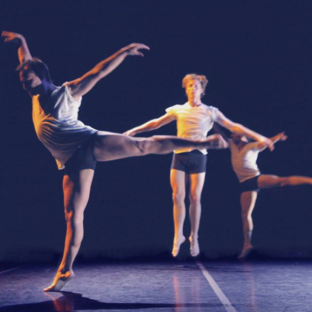 2 men in arabesque with one man jumping