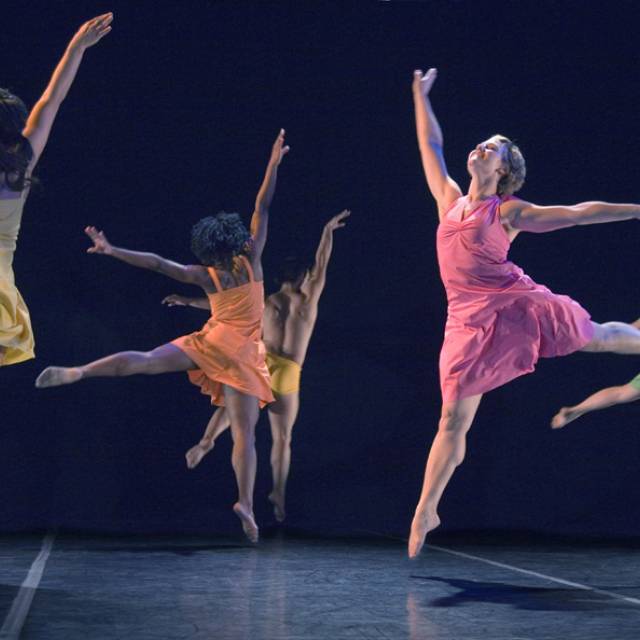 5 dancers jump with arms and legs outstretched