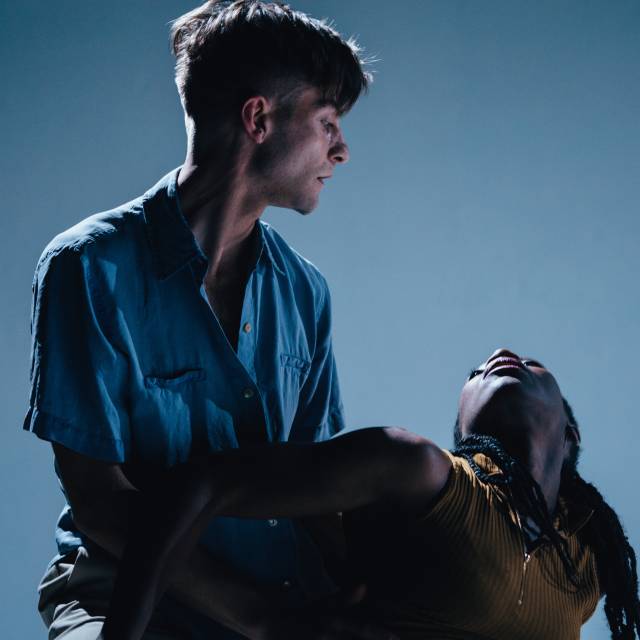 woman looks up toward a man 