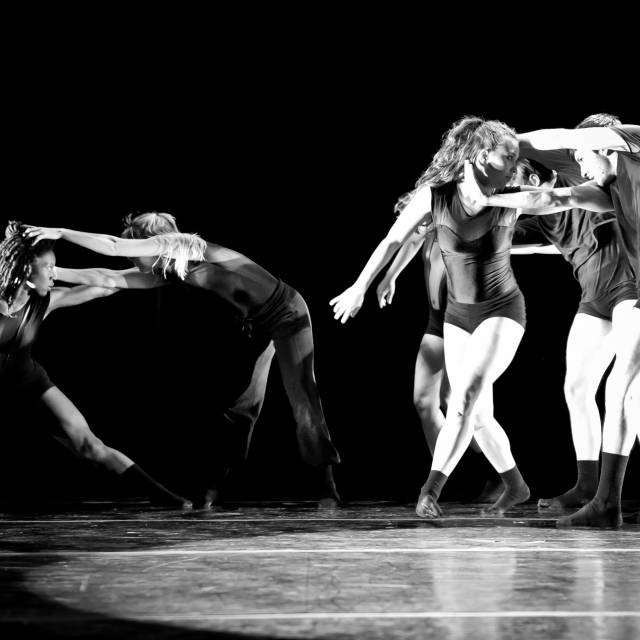 pairs of bodies reach toward each others heads