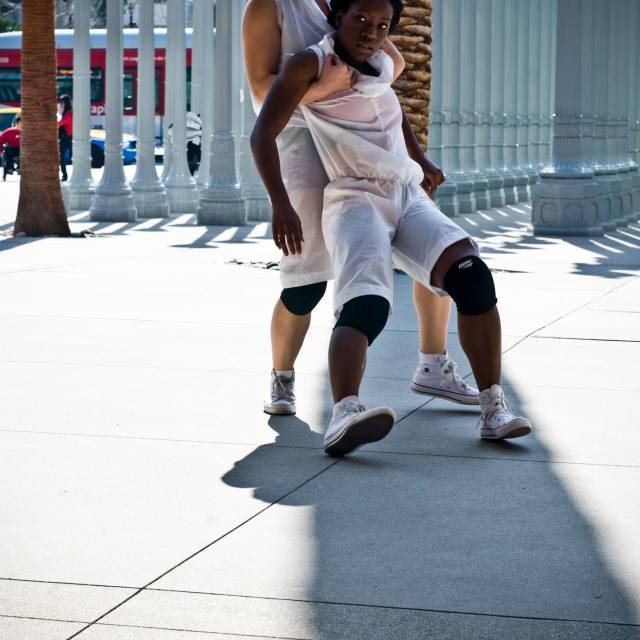 a woman holds the weight of another woman