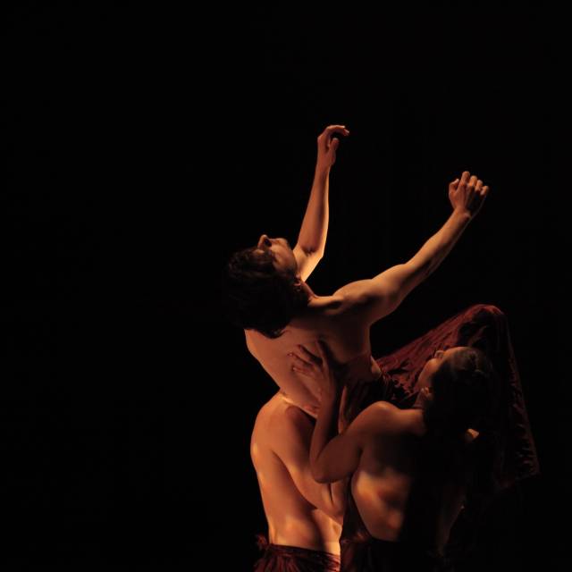 man is lifted by two figures