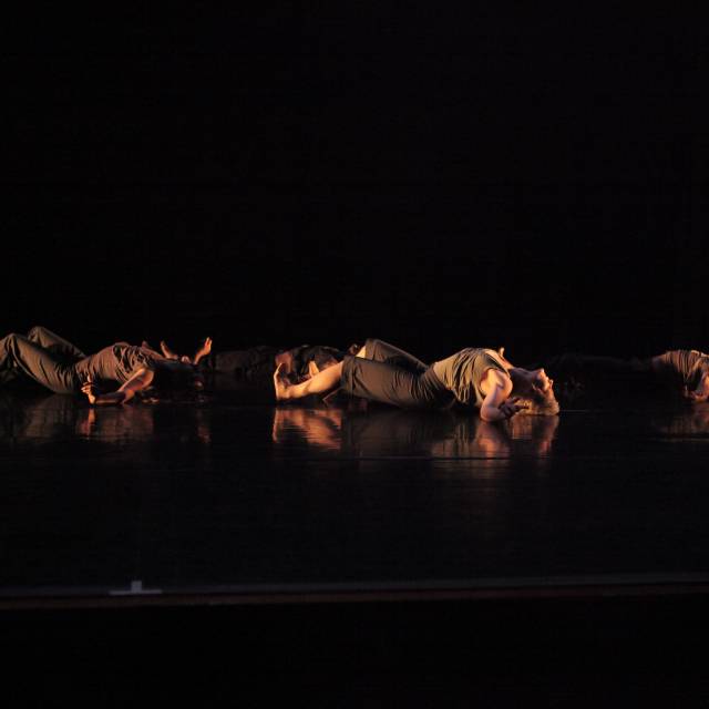 a group of people laying on the floor with their backs arched