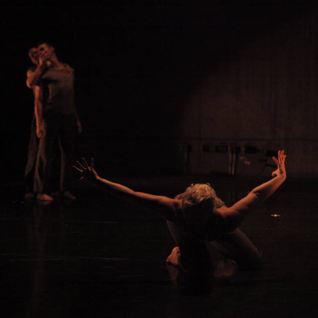woman on her knees with arms outstretched