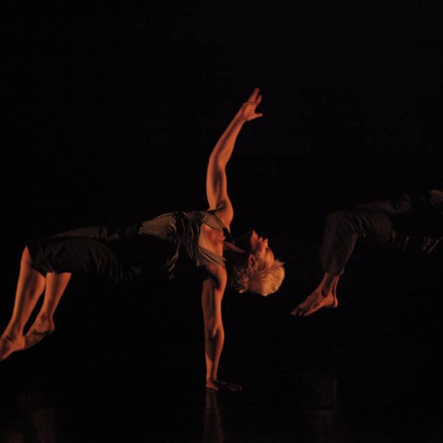 a man and woman throw themselves off of the floor