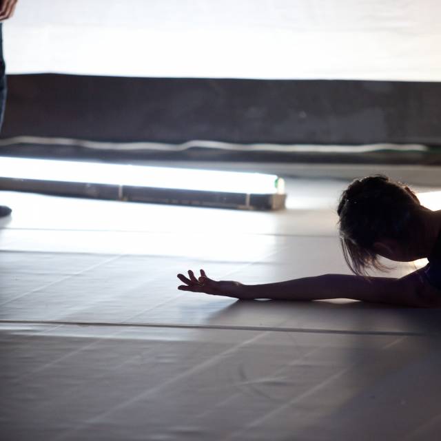 woman lays on her side with one arm outstretched