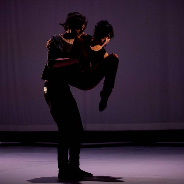 man holds a woman in the air