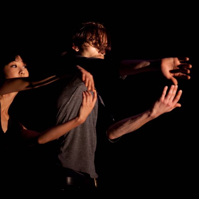 woman and man with arms outstretched