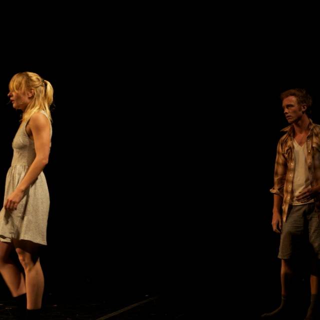 a man watches a woman walk away