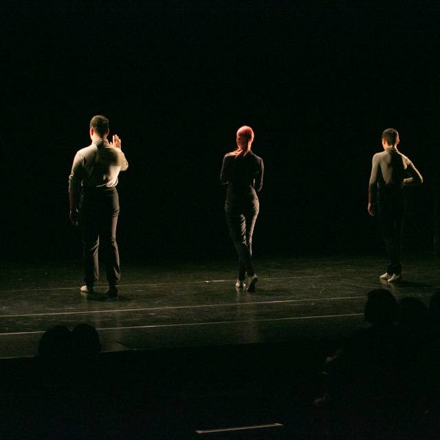 five people walk toward upstage