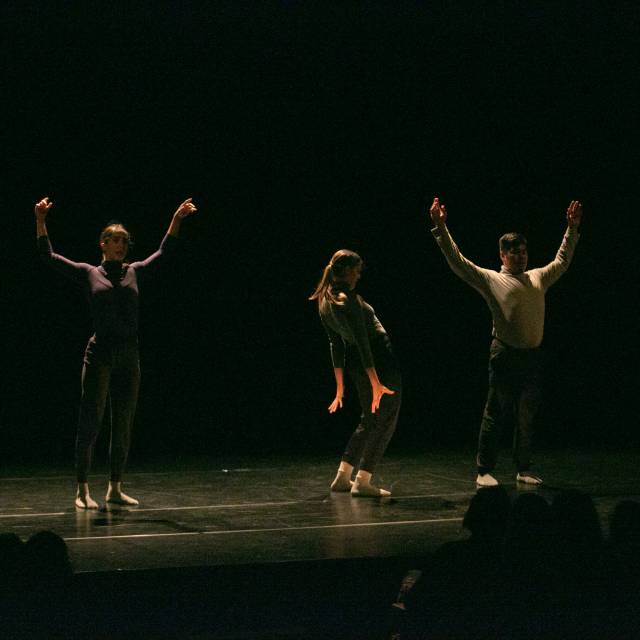 two dancers with raised arms and three dancers in profile with lowered arms