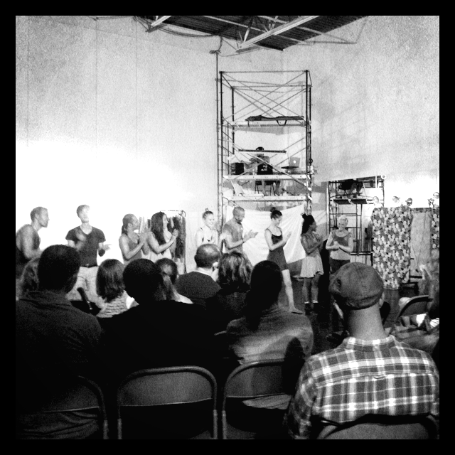 an audience watches a group of dancers during a curtain call