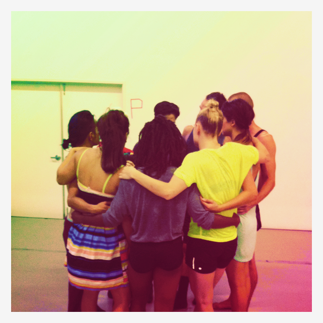 a group of people huddle in a circle