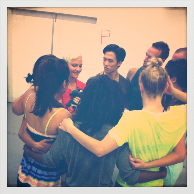 a group of people embrace in a huddle