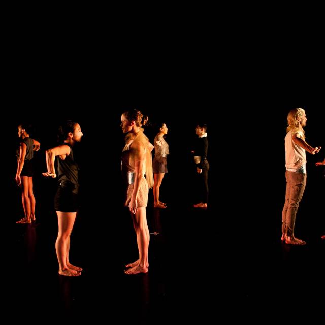 a group of dancers in pairings face off