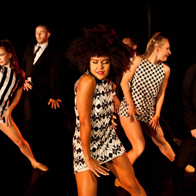 three women and one man in mid-movement