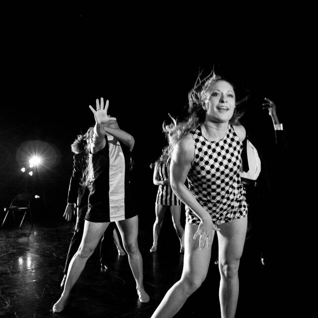 a woman backs away from the camera