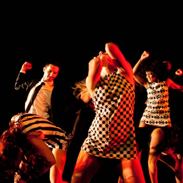 a group of dancers thrash around