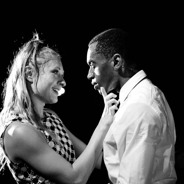 a woman cradles the face of a man with her hand