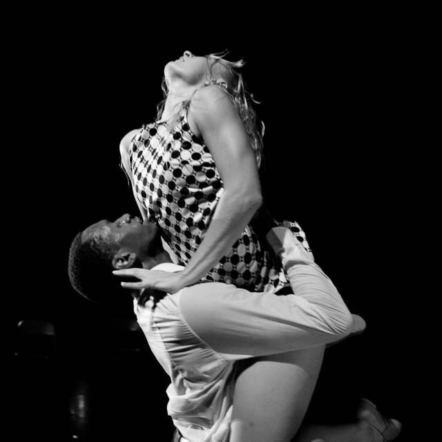 a man lifts a woman above his head