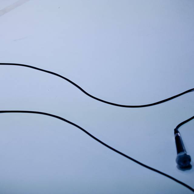 a microphone and its cord on the floor