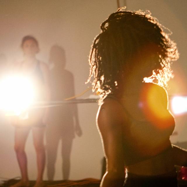 a woman faces the audience with her hair covering her face