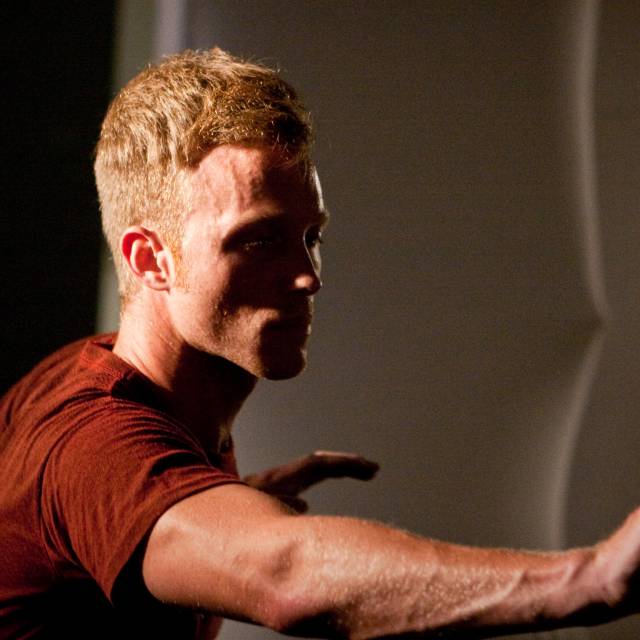 a man extends one arm outward