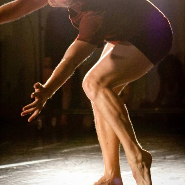a man twists his body has he bends over