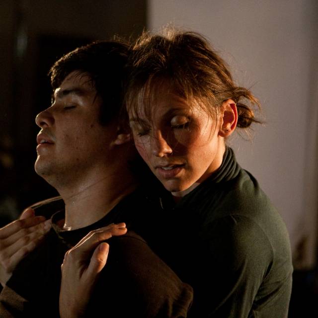 a woman hugs a man from behind