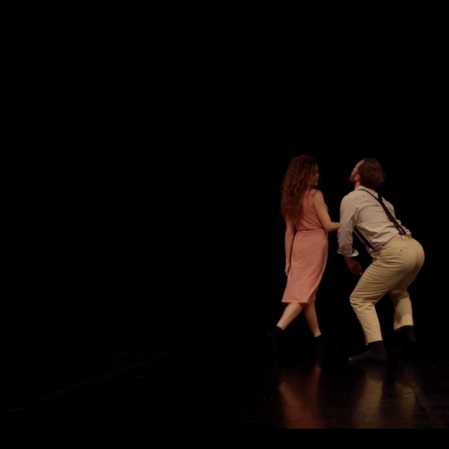 a woman walks by a man who wilts for her