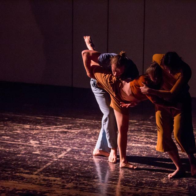 a man and a woman support a woman in an arabesque
