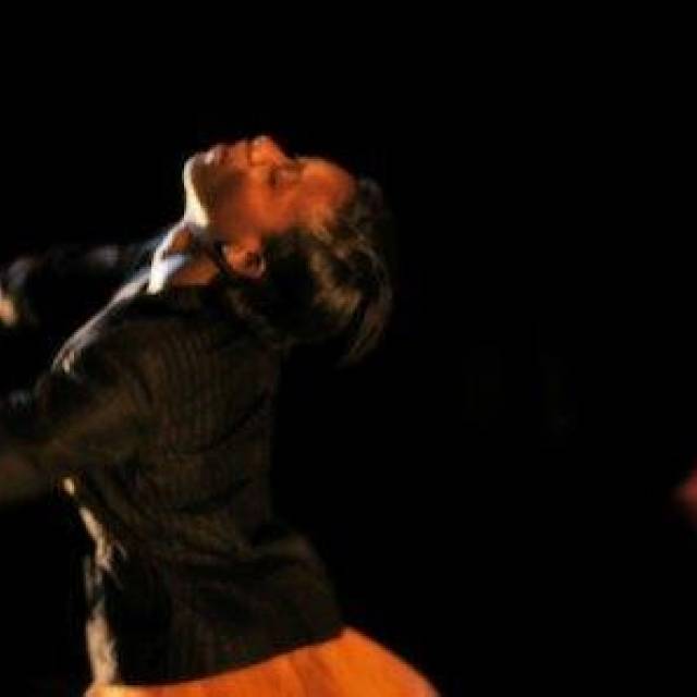 a woman with her head thrown back and arms stretched forward