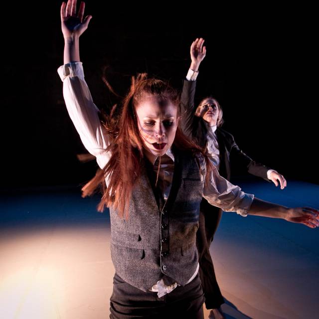 two women raise their arms