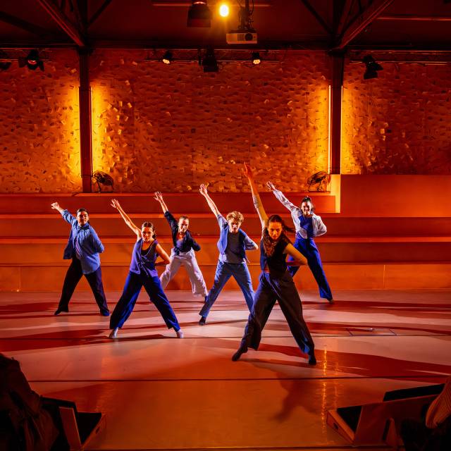 6 dancers in mid-step with one arm raised